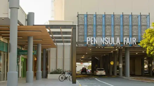 Visit redcliffe QLD image showing the outside building of the Peninsula fair shopping centre, with the Peninsula sign 